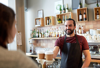 Image showing man or waiter serving customer in coffee shop