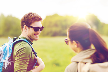 Image showing smiling couple with backpacks in nature