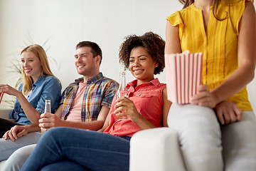 Image showing happy friends with popcorn watching tv at home