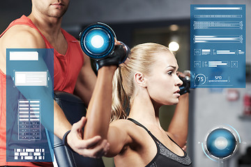 Image showing man and woman with dumbbells in gym