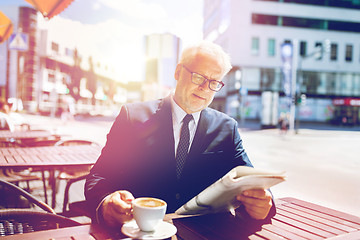 Image showing senior businessman with newspaper drinking coffee