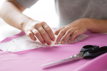 Image showing woman with pattern and chalk drawing on fabric