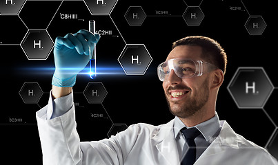 Image showing smiling scientist in goggles with test tube