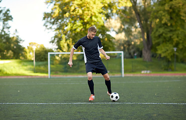 Image showing soccer player playing with ball on football field