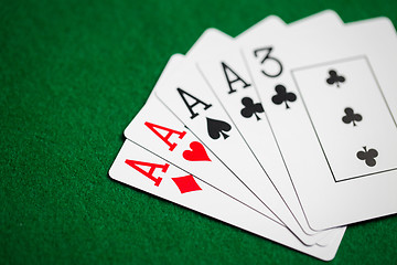 Image showing poker hand of playing cards on green casino cloth