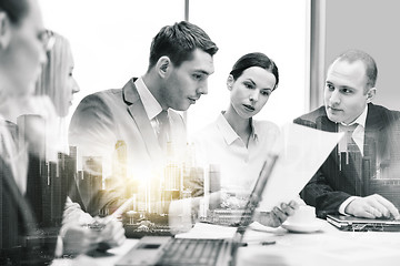 Image showing business team with laptop and papers at office