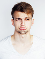 Image showing young handsome teenage hipster guy posing emotional, happy smiling against white background isolated, lifestyle people concept 