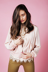 Image showing young pretty teenage woman emotional posing on pink background, fashion lifestyle people concept