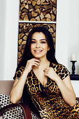 Image showing pretty stylish woman in fashion dress with leopard print together in luxury rich room interior, lifestyle people concept, modern brunette together