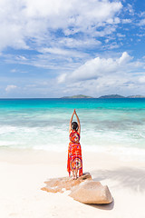 Image showing Woman enjoying Anse Patates picture perfect beach on La Digue Island, Seychelles.