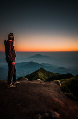 Image showing Hiker looking at mountains