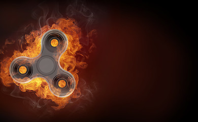 Image showing Fidget spinner in fire isolated on black background banner.