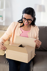 Image showing happy young indian woman with parcel box at home