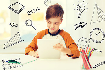 Image showing smiling boy with tablet pc and notebook at home