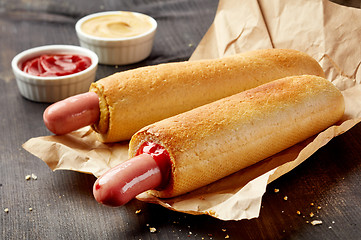 Image showing Two hotdogs on wooden table