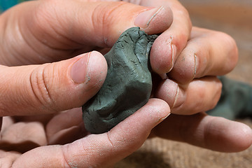 Image showing women's hands with clay