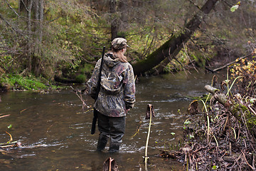 Image showing woman hunter crossing the river