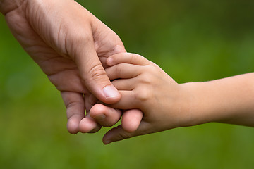 Image showing adult holding a child's hand