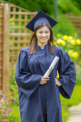 Image showing Graduated young woman smiling at camera