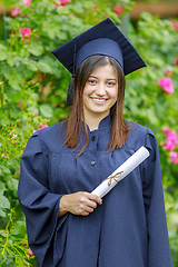 Image showing Graduated young woman smiling at camera