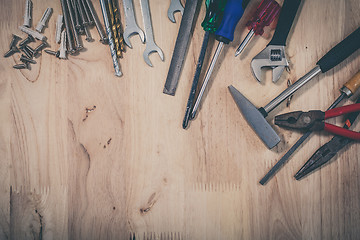 Image showing Set of different tools on wooden background