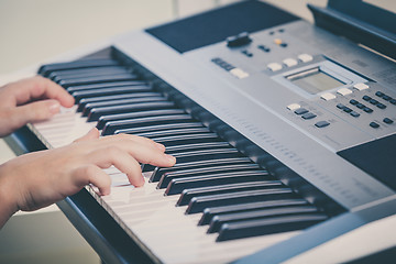 Image showing Little girl playing synthesizer