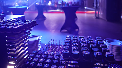 Image showing stylish luxury decorated orange candy bar for the celebration of a wedding of happy couple, cathering in the restaurant.