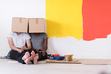 Image showing young multiethnic couple playing with cardboard boxes