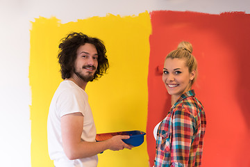 Image showing couple painting interior wall