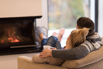 Image showing Young couple  in front of fireplace