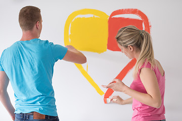 Image showing couple are painting a heart on the wall