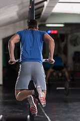 Image showing man doing exercises parallel bars