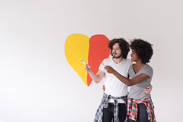 Image showing couple with painted heart on wall