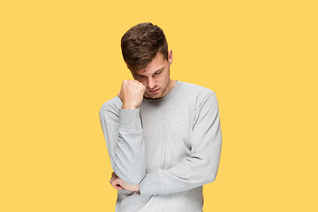 Image showing Tired businessman or The serious young man over yellow studio background with headache emotions