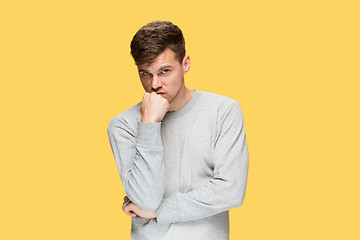 Image showing Tired businessman or The serious young man over yellow studio background with headache emotions