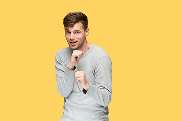 Image showing The young man with a raised fist