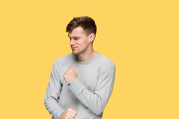 Image showing The young man with a raised fist