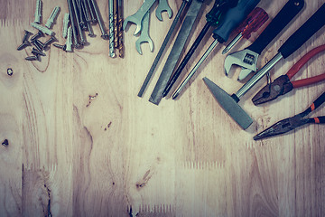 Image showing Set of different tools on wooden background