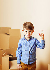 Image showing little cute boy in empty room, remoove to new house. home alone,