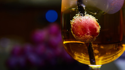 Image showing Grapes floating in champagne creating lots of bubbles