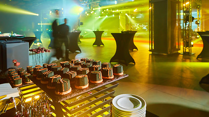 Image showing stylish luxury decorated orange candy bar for the celebration of a wedding of happy couple, cathering in the restaurant.