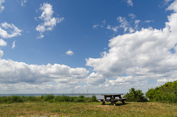 Image showing Wooden bench and table by the coast