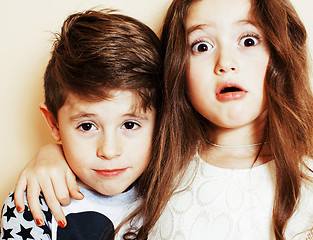 Image showing little cute boy and girl hugging playing on white background, ha