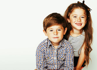 Image showing little cute boy and girl hugging playing on white background, ha