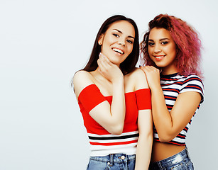 Image showing lifestyle people concept: two pretty stylish modern hipster teen girl having fun together, diverse nation mixed races, happy smiling making selfie 