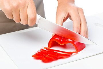 Image showing Cook is chopping bell pepper