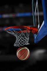 Image showing basketball ball and net on black background