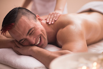 Image showing young man having a back massage