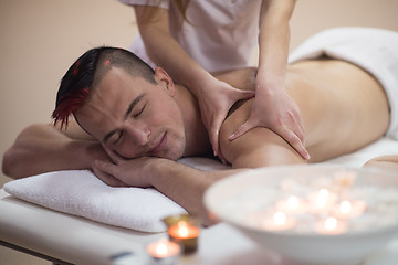 Image showing young man having a back massage