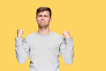 Image showing The young man with a raised fist